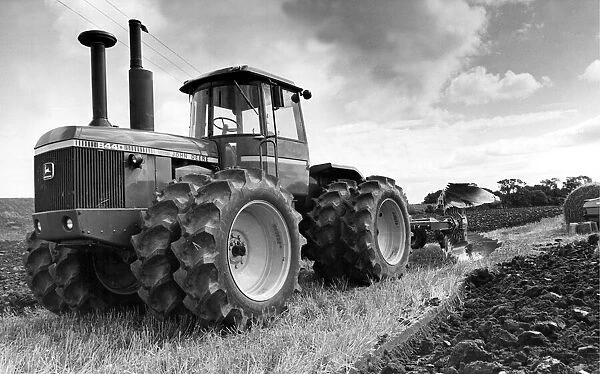 A John Deere 8440s tractor pulling a plough