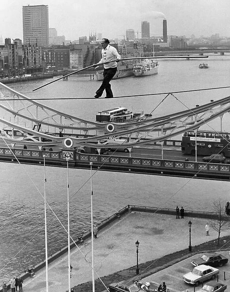 Karl Wallenda successfully walks 100 feet above the ground near Tower Bridge