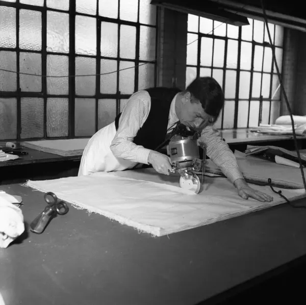 Latex being cut for straps for corsets and girdles at the Spirella Corset factory in