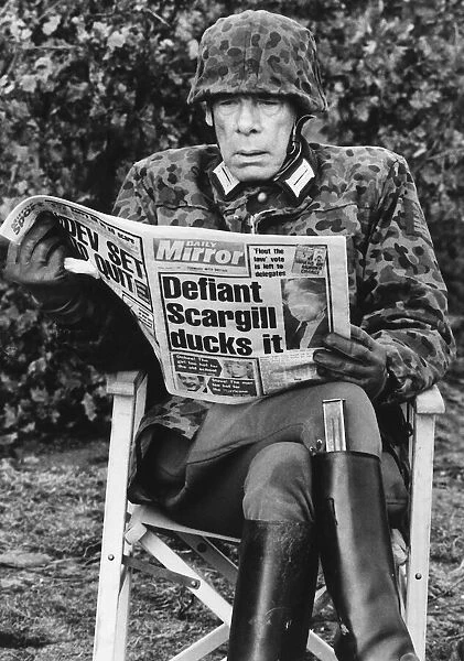 Lee Marvin American actor, reading the Daily Mirror. December 1984