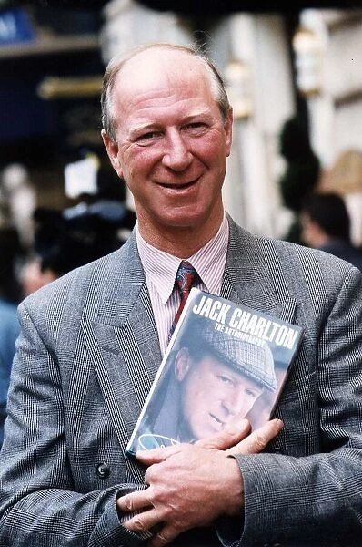 Former Leeds United and England footballer Jack Charlton holding his autobiography