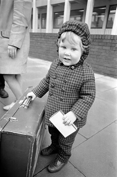 Little boy holding on to a suitcase. November 1969 Z11024-005