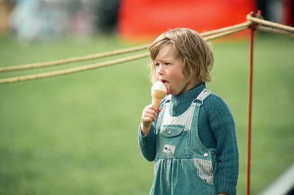 A little girl enjoys an ice-cream at Kirkleatham Country Fayre. 1st August 1993