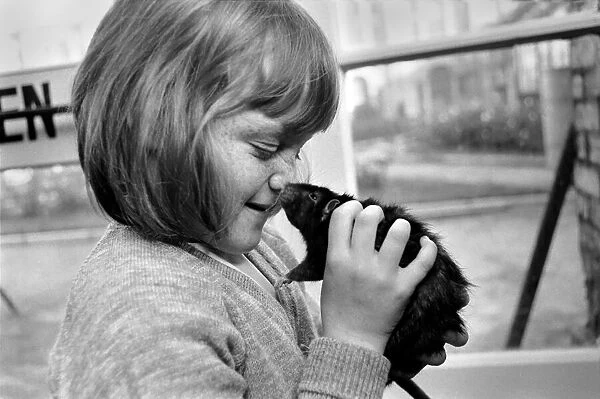 Little girl holding a rat. November 1969 Z10521-001