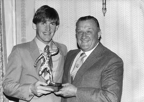 Liverpool footballer Kenny Dalglish recieves an award from manager Bob Paisley