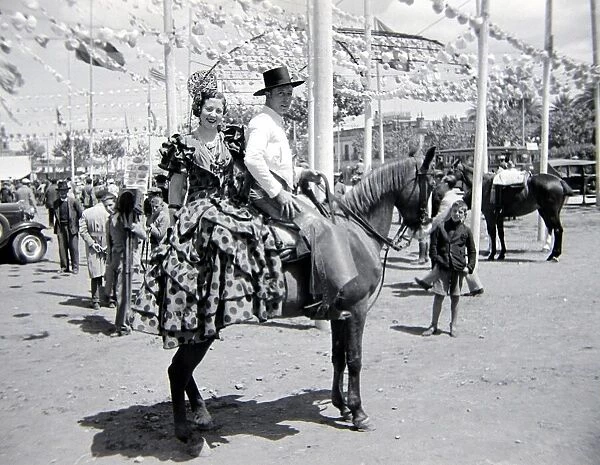 Local couple of Seville, Spain on horseback Circa 1935