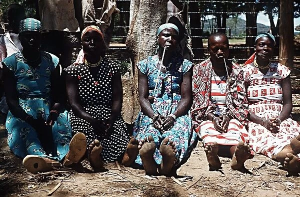 Luo women smoking traditional pipes Nyanza Province South West Kenya Africa