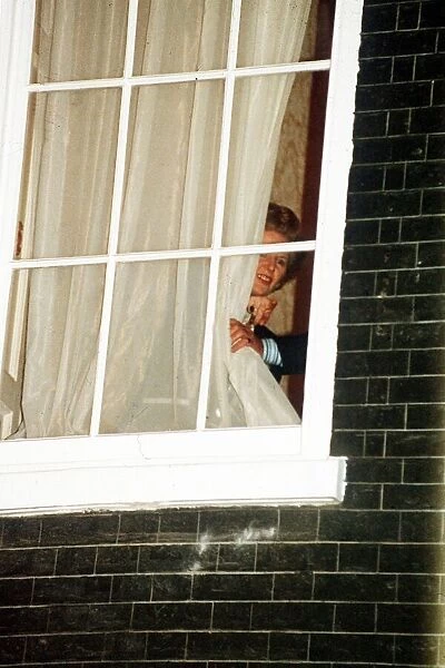 Margaret Thatcher watches through the window at No 10 Downing Street 1990