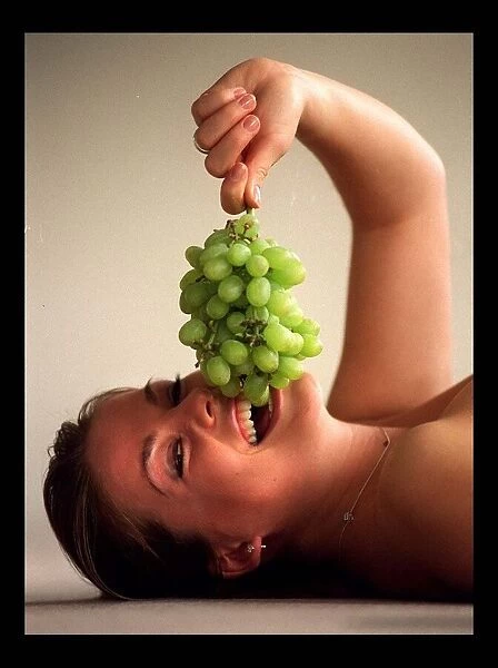 Model eating grapes March 1998