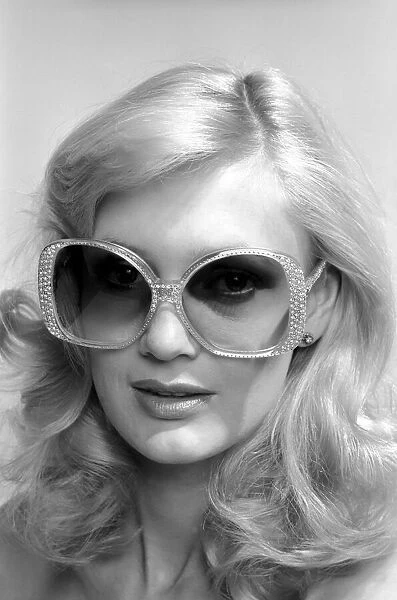 Model Maria wearing a pair of sunglasses. June 1980 80-03010-002