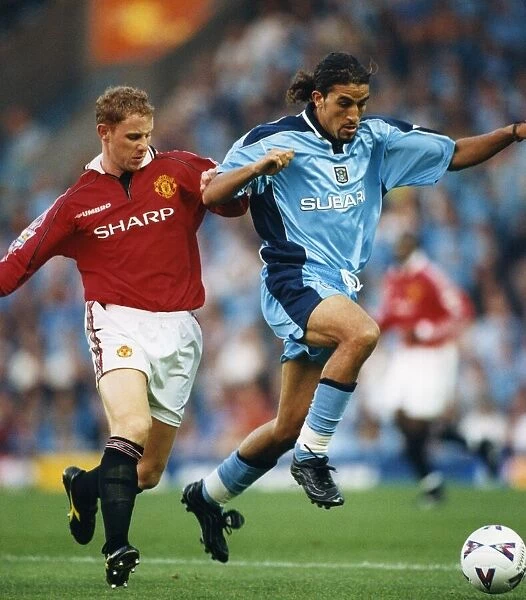Moroccan-born Sky Blues player Moustapha Hadji and Manchester United's Nicky Butt