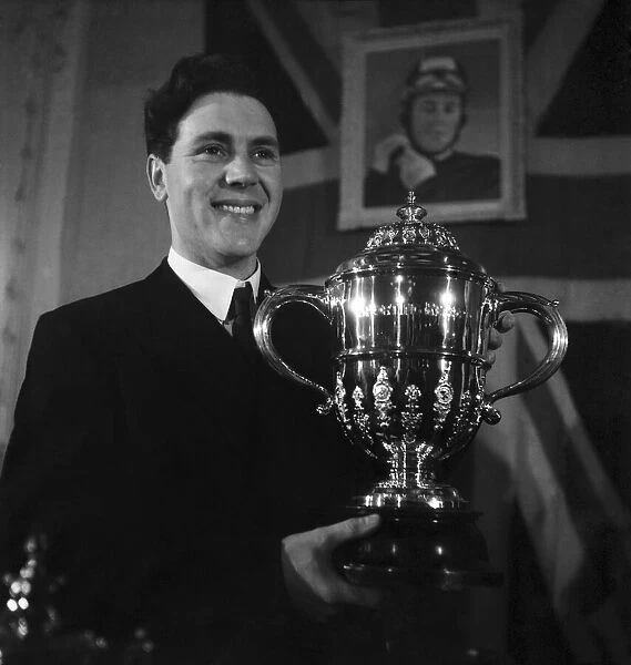 Motorcycle racing champion Geoff Duke with the World Championship trophy