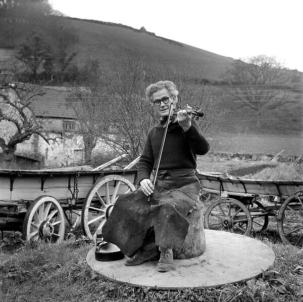 Mr. Harry Horrobin playing his violin outside. January 1975 75-00196