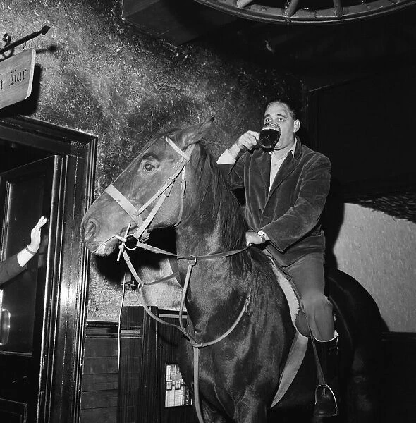 Mr Leslie Johnson rides his horse 'Lady'into the bar of the Fox and Goose