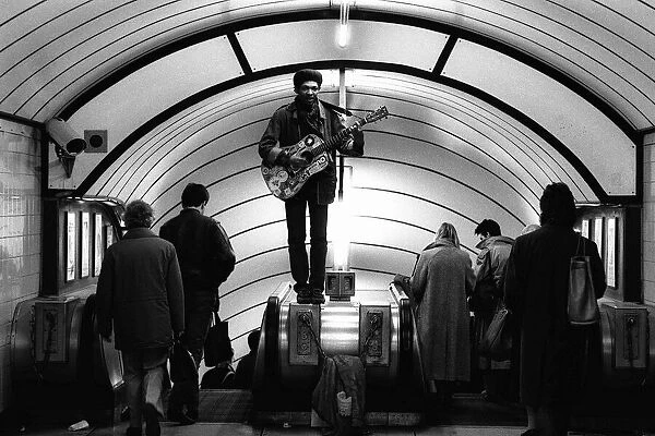 A musician busking at Oxford Circus Station - February 1987 standing