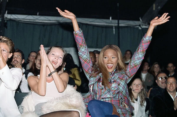Naomi Campbell model sitting next to supermodel Kate Moss cheers a winner at British