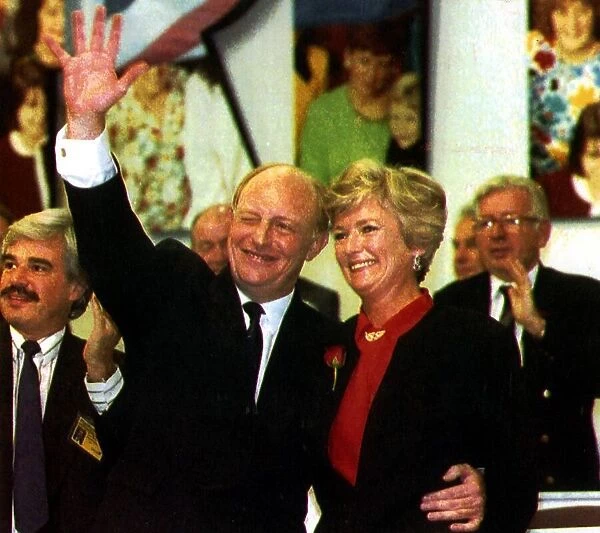 Neil Kinnock MP and his wife Glenys wave from the podium at the Labour Party Conference