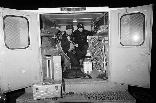 Two New York Policemen in the back of their truck with their equipment