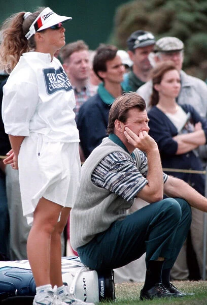 Nick Faldo sits down on his golf bag during his 74 in the first round of the British Open