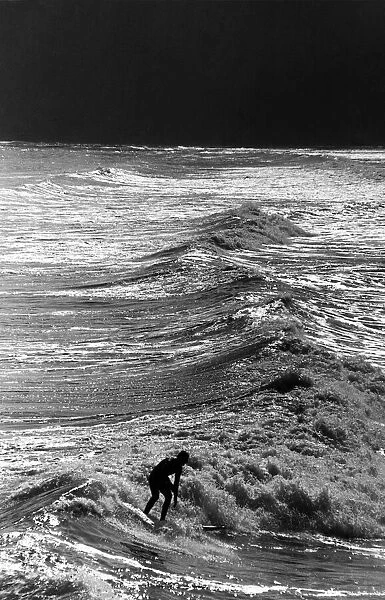 Nick Noble surfing on the crest of a wave off Saltburn pier. 20th May 1988