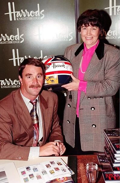 NIGEL MANSELL AND WOMAN AT HARRODS PROMOTION HOLDING A DRIVING HELMET 08  /  12  /  1992