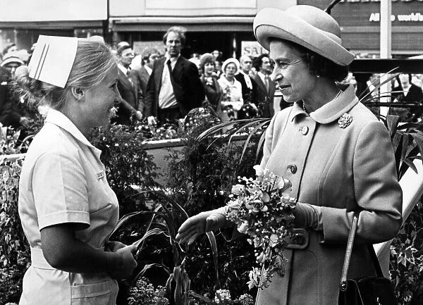Nurse Susan Laskey presents a bouquet to Queen Elizabeth II as she arrives at Stockton
