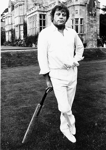 Oliver Reed Film Actor awaits his turn to bat in the grounds of a stately home