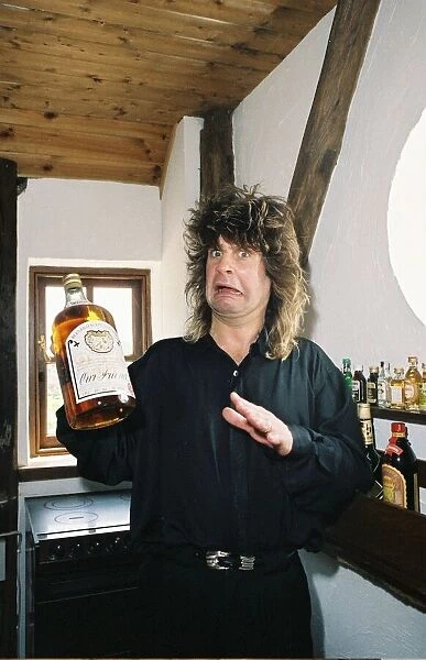 Ozzy Osbourne rock singer with the group Black Sabbath, holding a bottle of whiskey at
