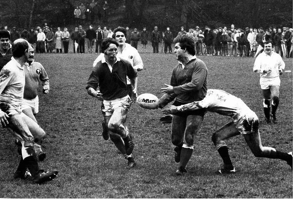 Pat Daniels, the Old Wales winger, passes the ball out to his team mate JPR Williams who