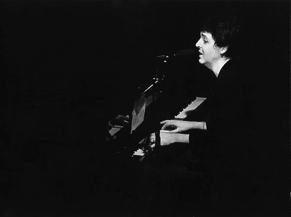 Paul McCartney pictured performing with Wings, in a concert at The Royal Court Theatre in