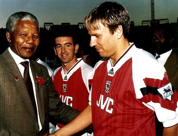 Paul Merson, football player for Arsenal FC, shakes hands with the President of South
