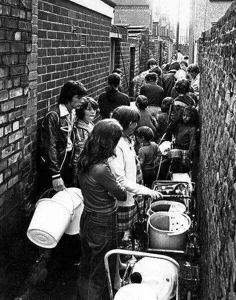 People queue in a back alley off David Street the Holy Land, in Dingle