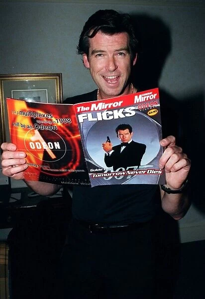 Pierce Brosnan 007 star with a copy of the December 1997 Mirror Flicks Magazine
