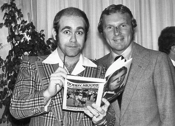 Pop star Elton John also chairman of Watford football club seen here with Bobby Moore at