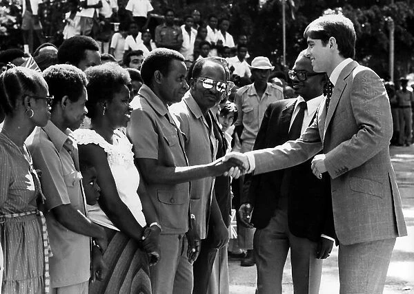 Prince Andrew at Dar Es Salaam during a visit to East Africa shaking hands with students