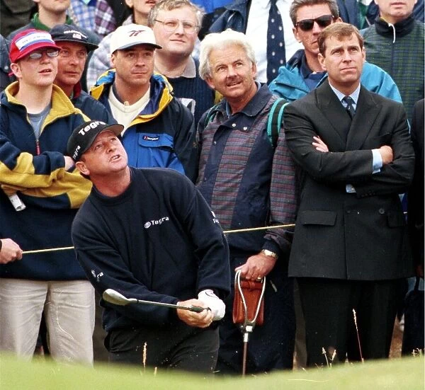 Prince Andrew watches Ian Woosham play out of a bunker during the third round of the Open