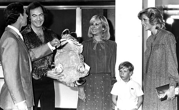 Prince Charles and Diana share a joke with singer Neil Diamond over a Garfield cuddly toy