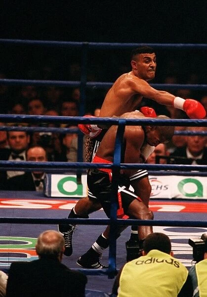 Prince Naseem Hamed lands a punch on Tom Boom Boom Johnson in their IBF world feather
