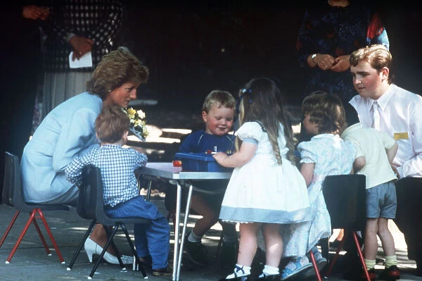 Princess Diana pictured with nursery school children during a visit to the Barnardo