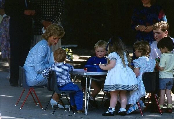 Princess Diana pictured with nursery school children during a visit to the Barnardo