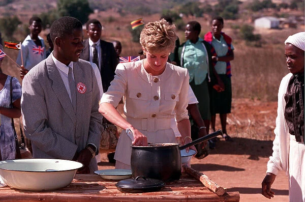 PRINCESS OF WALES DISHING OUT FOOD DURING A VISIT TO RED CROSS CHARITY PROJECT IN