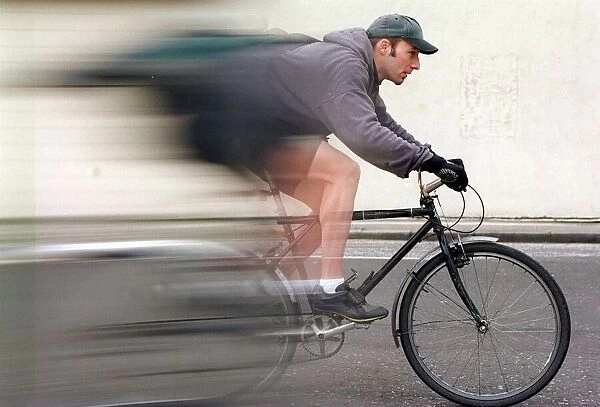 Pushbike courier Brain Dunsmore speeds on bike wearing cap and gloves October 1997