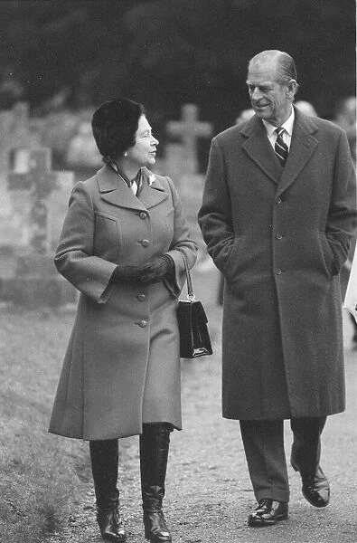 Queen Elizabeth II and Prince Philip walking through Sandringham. February 1986