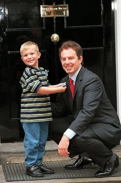Recovered cancer patient Alexander Taylor (4 ) from Staffordshire presents Prime Minister