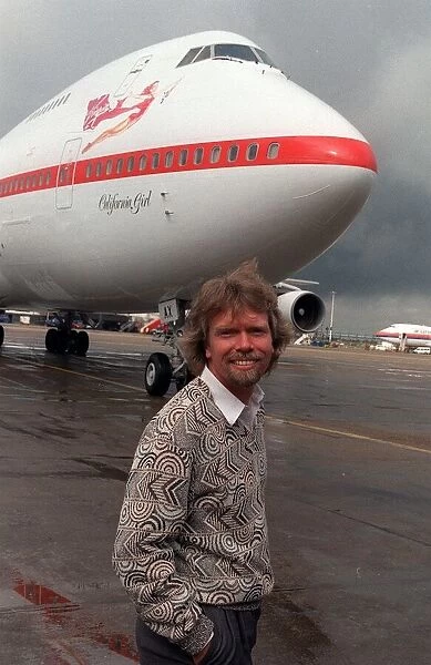 Richard Branson standing in front of one of his Virgin Airways Boeing 747 jumbo jet