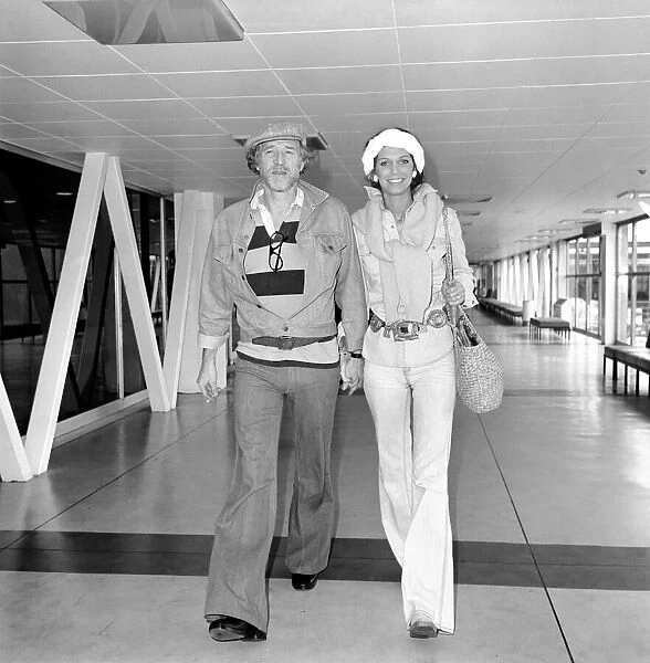Richard Harris and his wife at London airport. July 1975