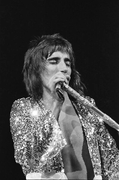 Rod Stewart singing onstage. The Faces featuring Rod Stewart perform at The