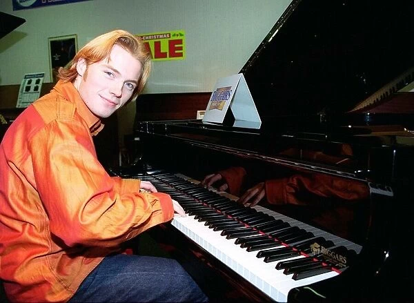 Ronan Keating from boy band Boyzone buys a baby Grand Piano from Biggars music shop in