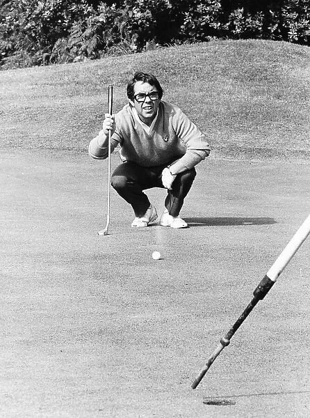 Ronnie Corbett Comedian crouches down to eye up a putt during a golf match dbase