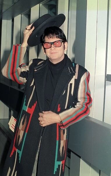 Roy Orbison at Heathrow Airport November 1988 in multi coloured coat holding